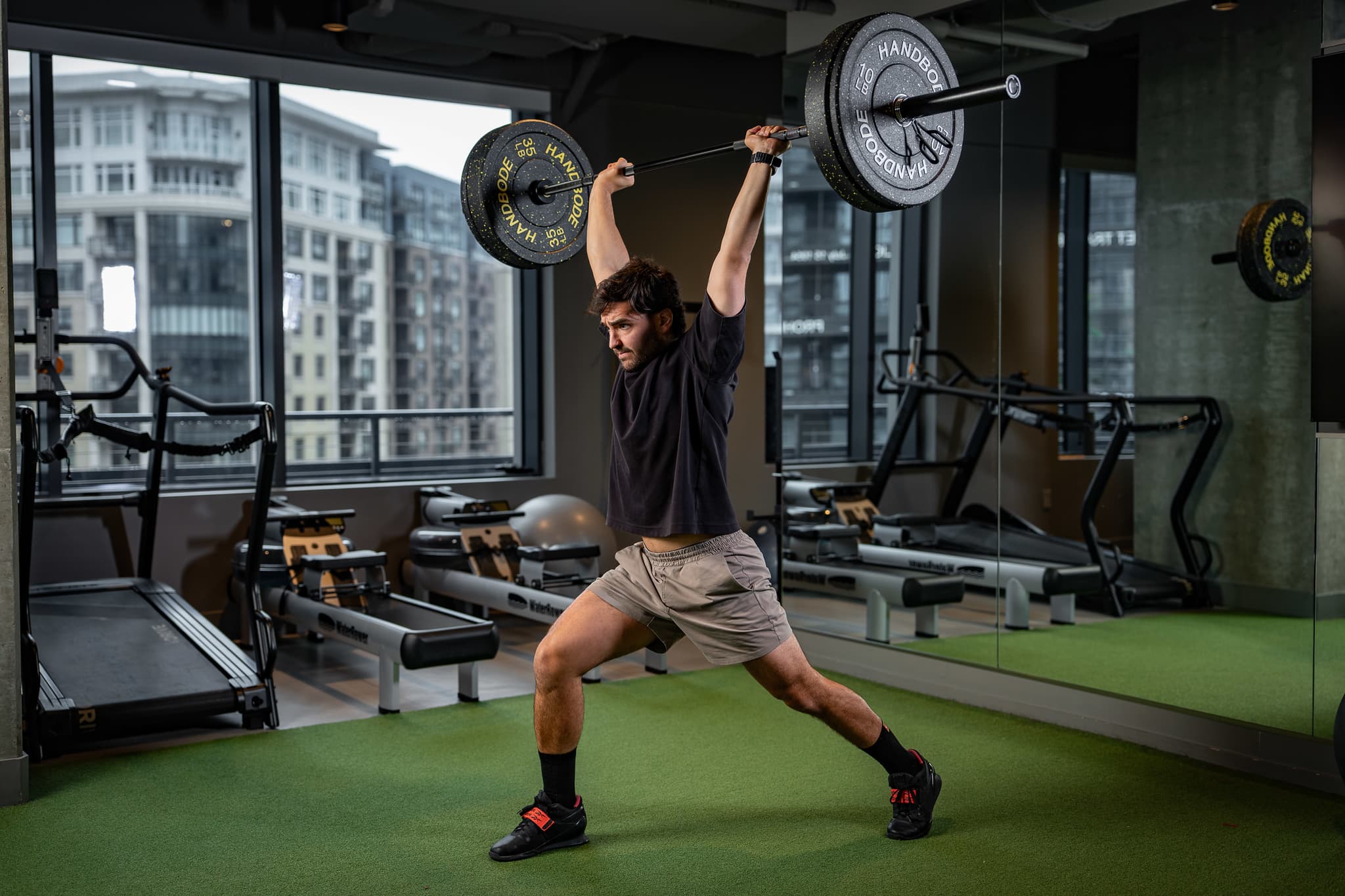 Athlete performing the overhead squat phase of a Snatch or Clean and Jerk during Olympic lifting and strength coaching.
